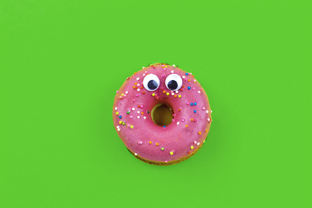 a donut with googley eyes and a surprised face