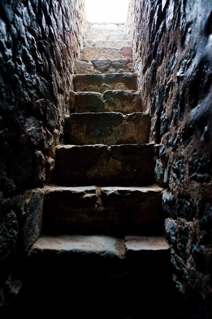 a set of stone steps leading to the light of day